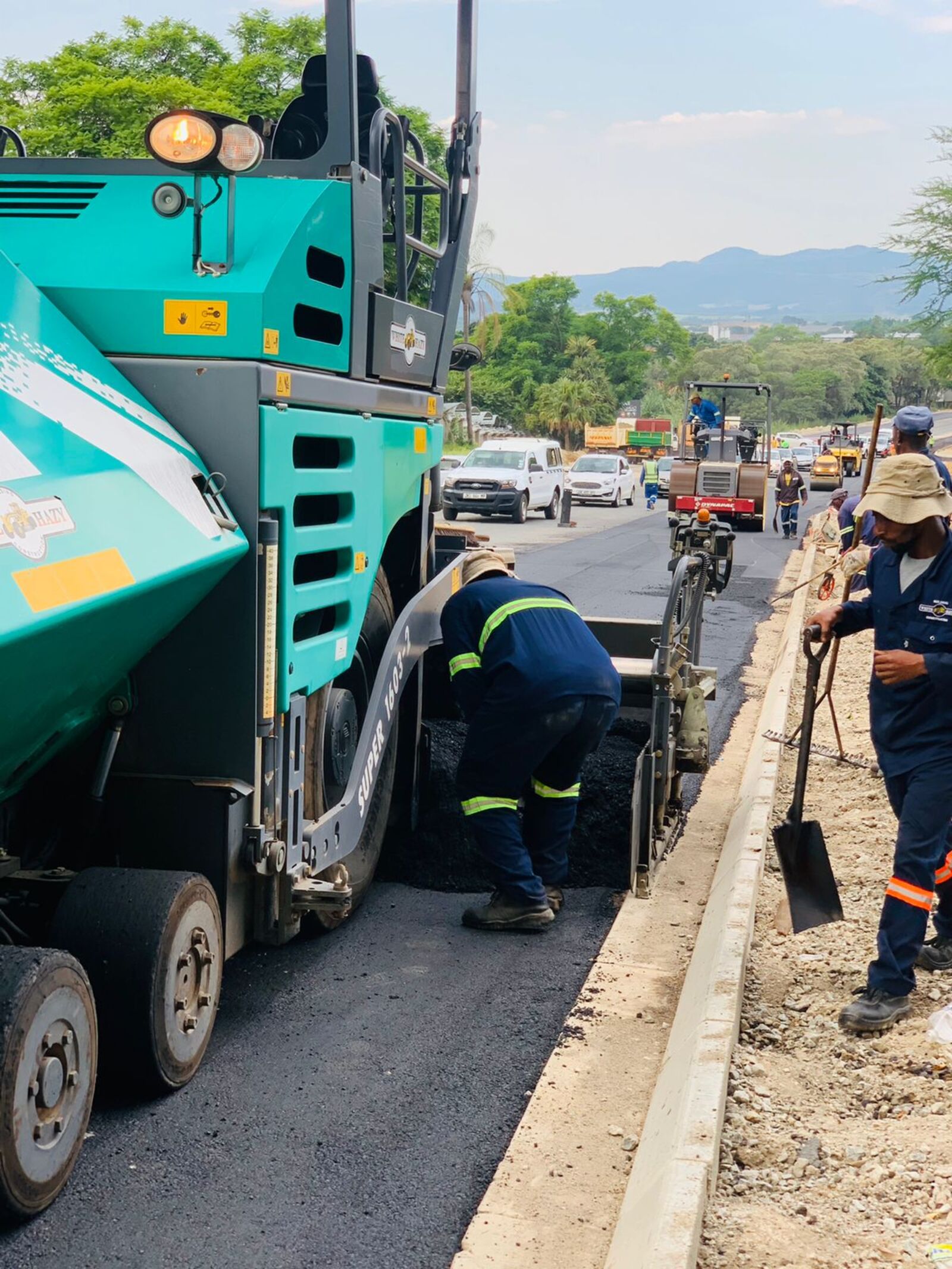 Asphalt paving and compaction on a road upgrade