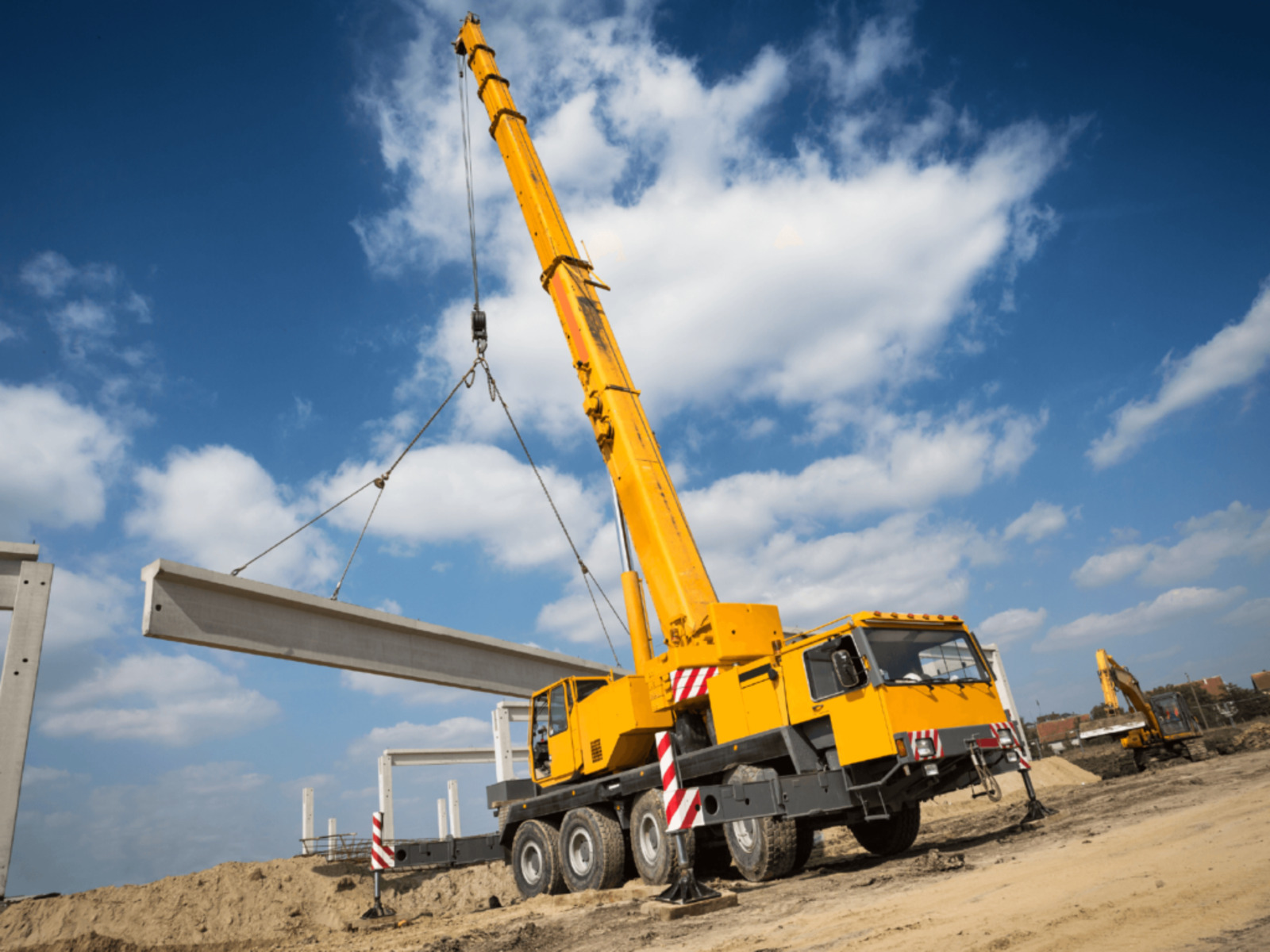 Mobile crane lifting a precast concrete beam