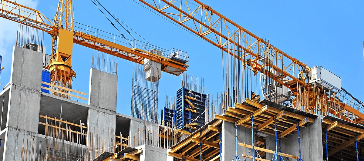 Tower cranes over a reinforced concrete building structure